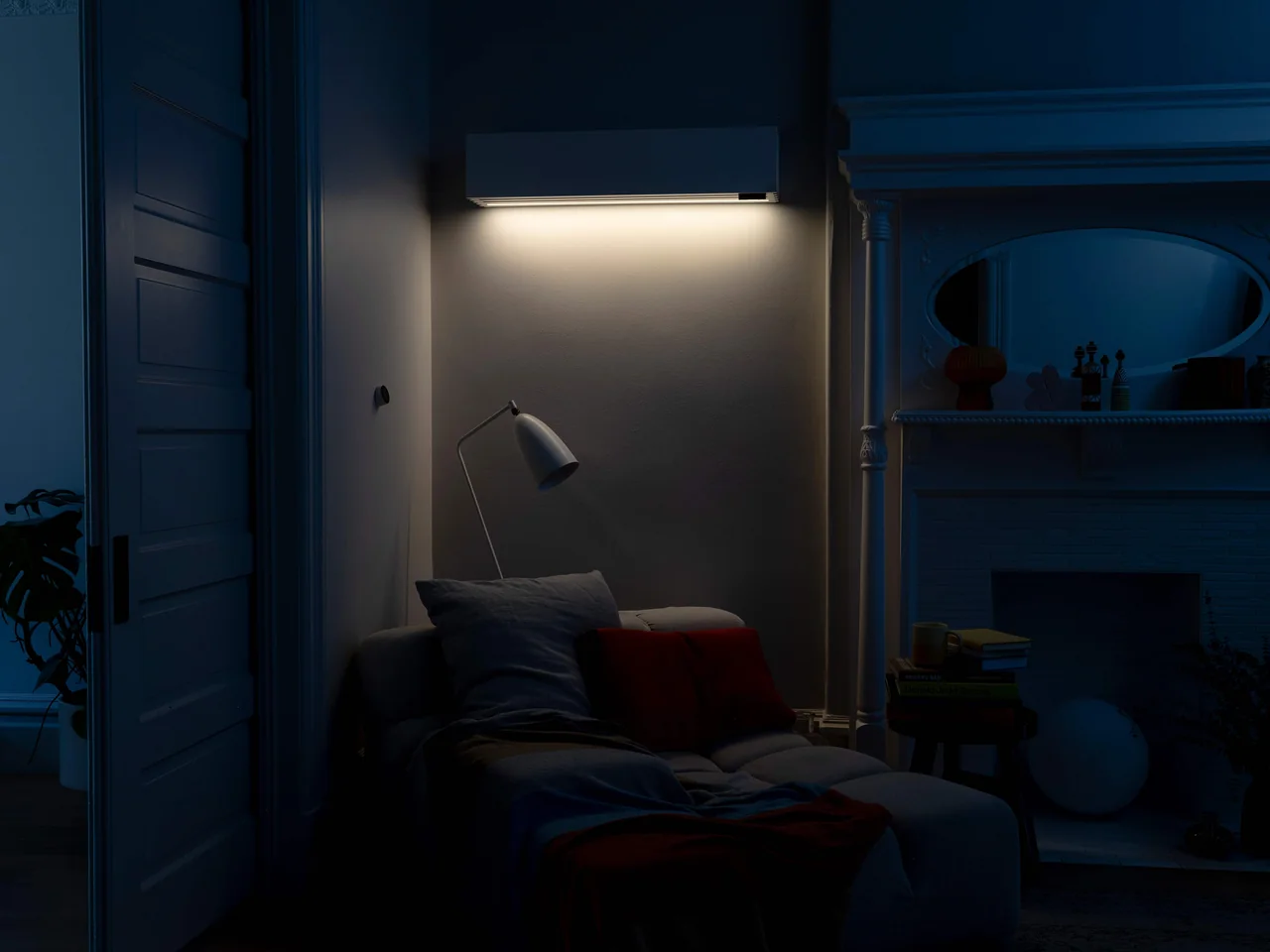Quilt indoor air handler with its accent light illuminating a living-room wall at night — official Quilt photography