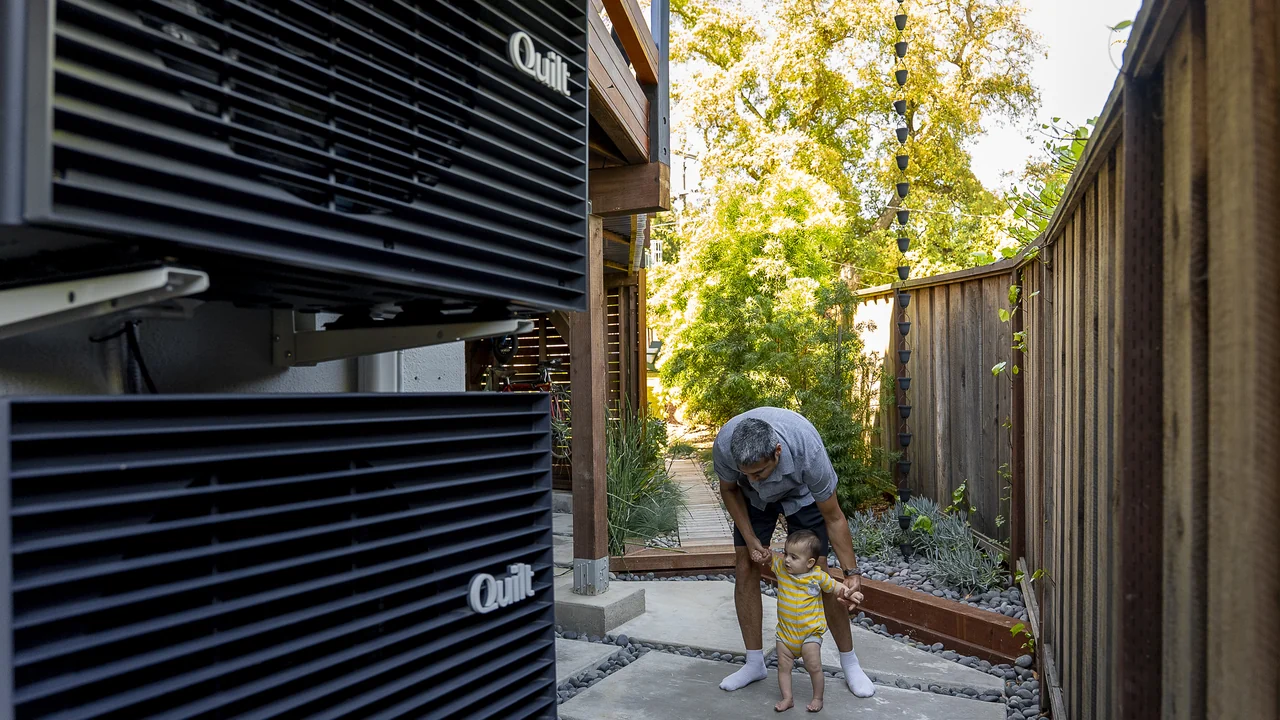 Black Quilt outdoor unit beside a home