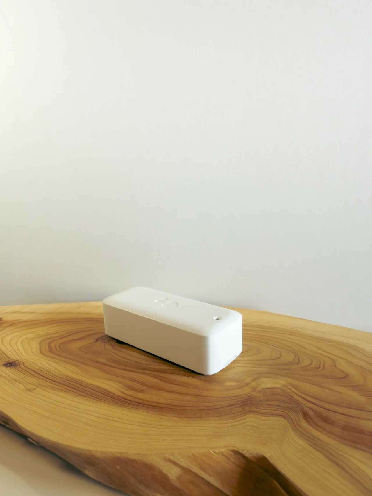 White external Quilt room Sensor on a wood tabletop