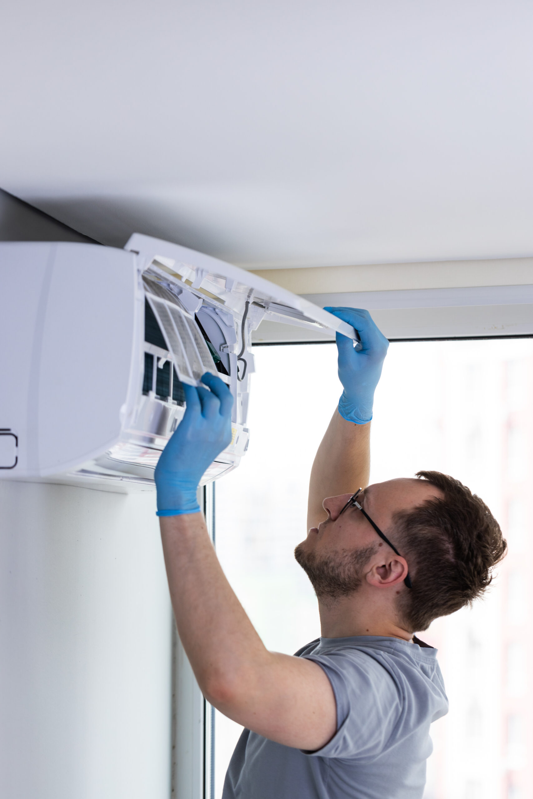 Freedom HVAC technician servicing a wall-mounted mini-split air handler in Seneca, MO to improve home comfort and energy efficiency.